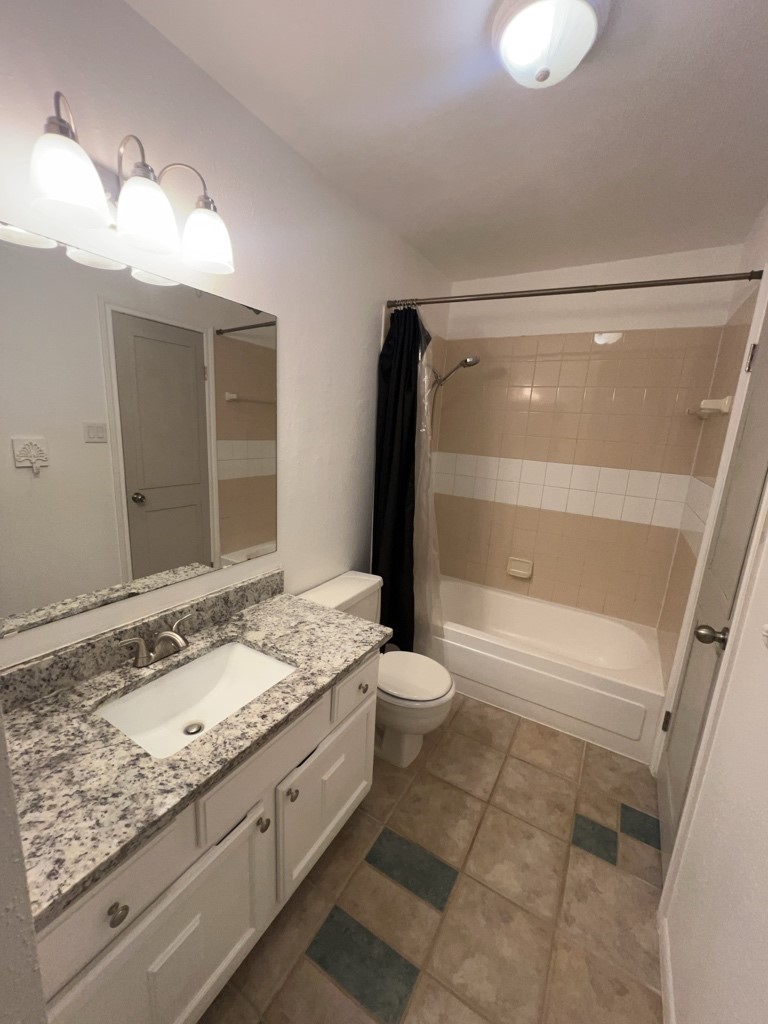 1919 Place Rebecca Lane, Unit H11 Houston, TX 77090 - Photo 13 of 18 a bathroom with a granite countertop sink toilet and shower