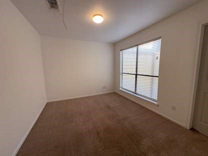 1919 Place Rebecca Lane, Unit H11 Houston, TX 77090 - Photo 8 of 18 an empty room with a window