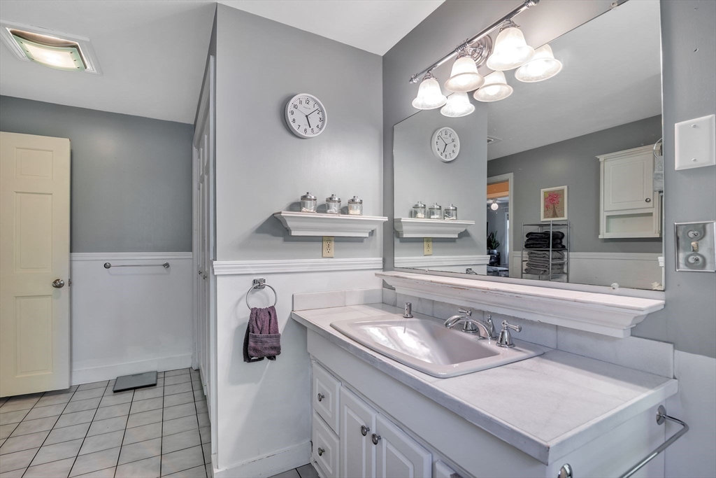 4 Stuart Road Rochester, MA 02770 - Photo 14 of 37 a kitchen with a sink and a stove top oven