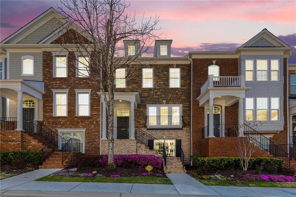 a front view of a residential apartment building with a yard
