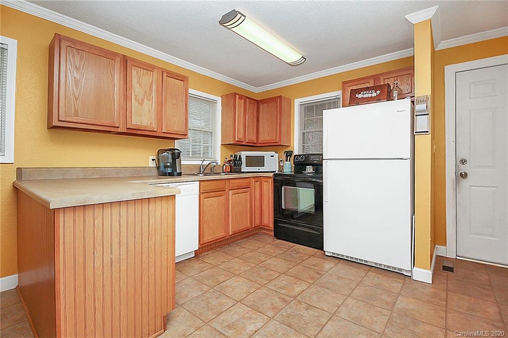 561 South Potter Road Lancaster, SC 29720 - Photo 12 of 33 a kitchen with a refrigerator sink stove and cabinets