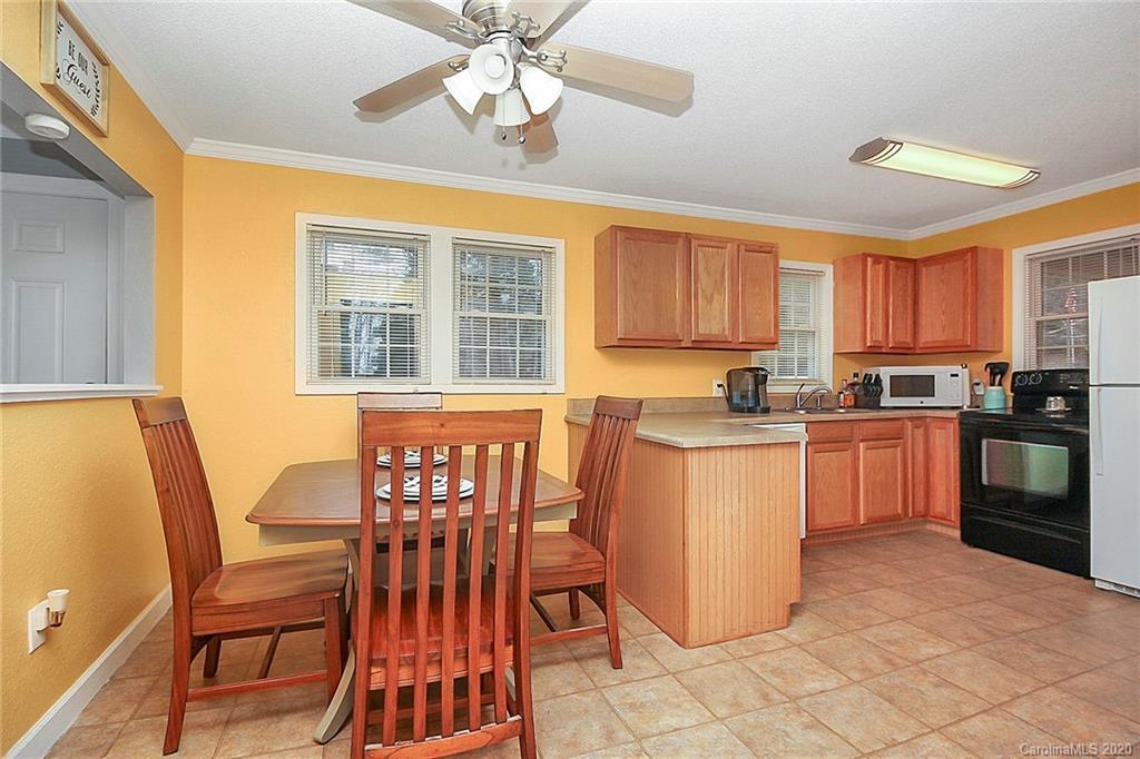 561 South Potter Road Lancaster, SC 29720 - Photo 15 of 33 a kitchen with a dining table chairs and refrigerator