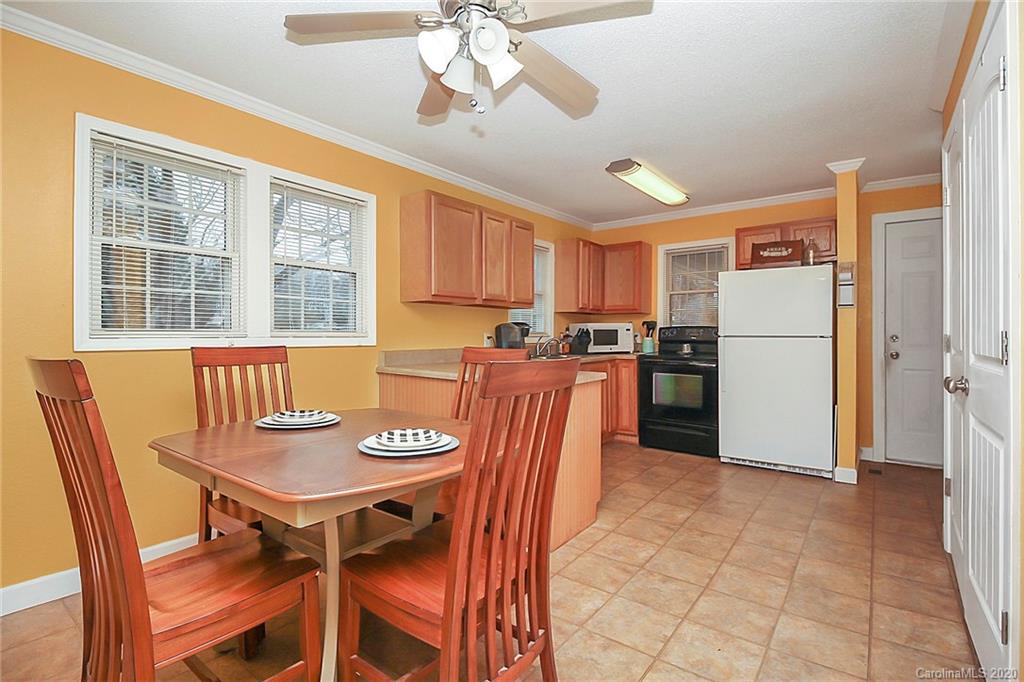 561 South Potter Road Lancaster, SC 29720 - Photo 16 of 33 a kitchen with stainless steel appliances granite countertop a dining table and chairs