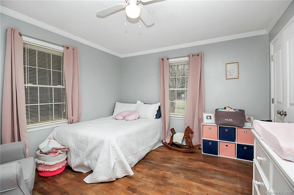 561 South Potter Road Lancaster, SC 29720 - Photo 23 of 33 a bedroom with a bed and wooden floor