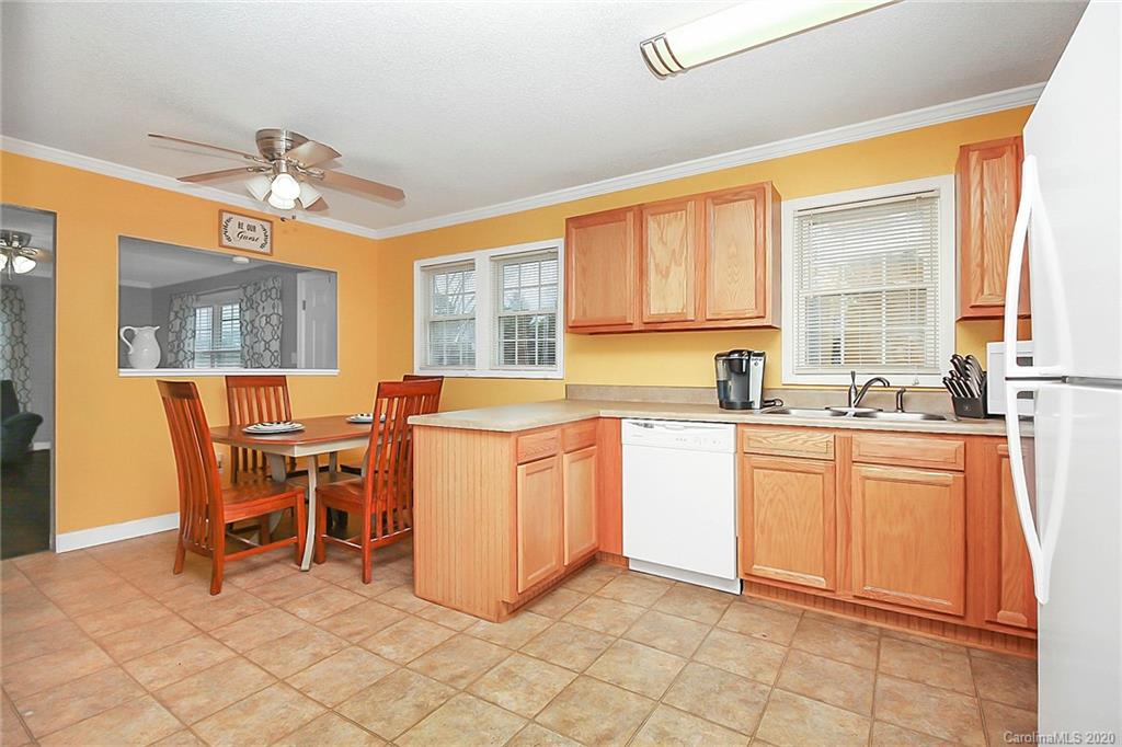 561 South Potter Road Lancaster, SC 29720 - Photo 10 of 33 a kitchen with granite countertop cabinets a dining table and chairs