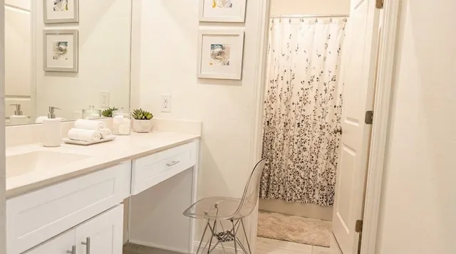 a bedroom with a bed and painting on the wall