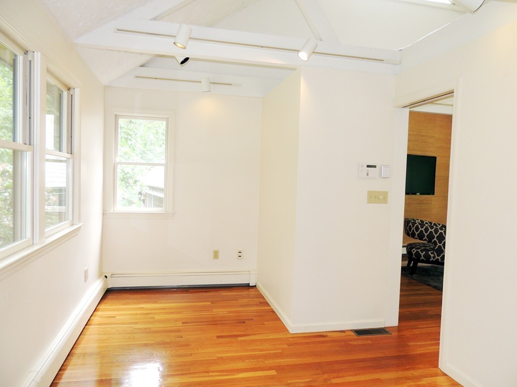 61 Judy Farm Road Carlisle, MA 01741 - Photo 13 of 24 a view of an empty room with wooden floor and a window