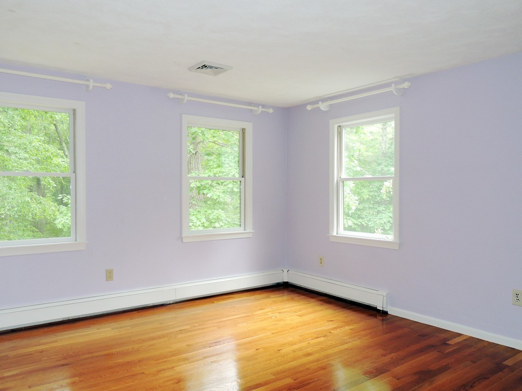 61 Judy Farm Road Carlisle, MA 01741 - Photo 15 of 24 a view of an empty room with wooden floor and a window
