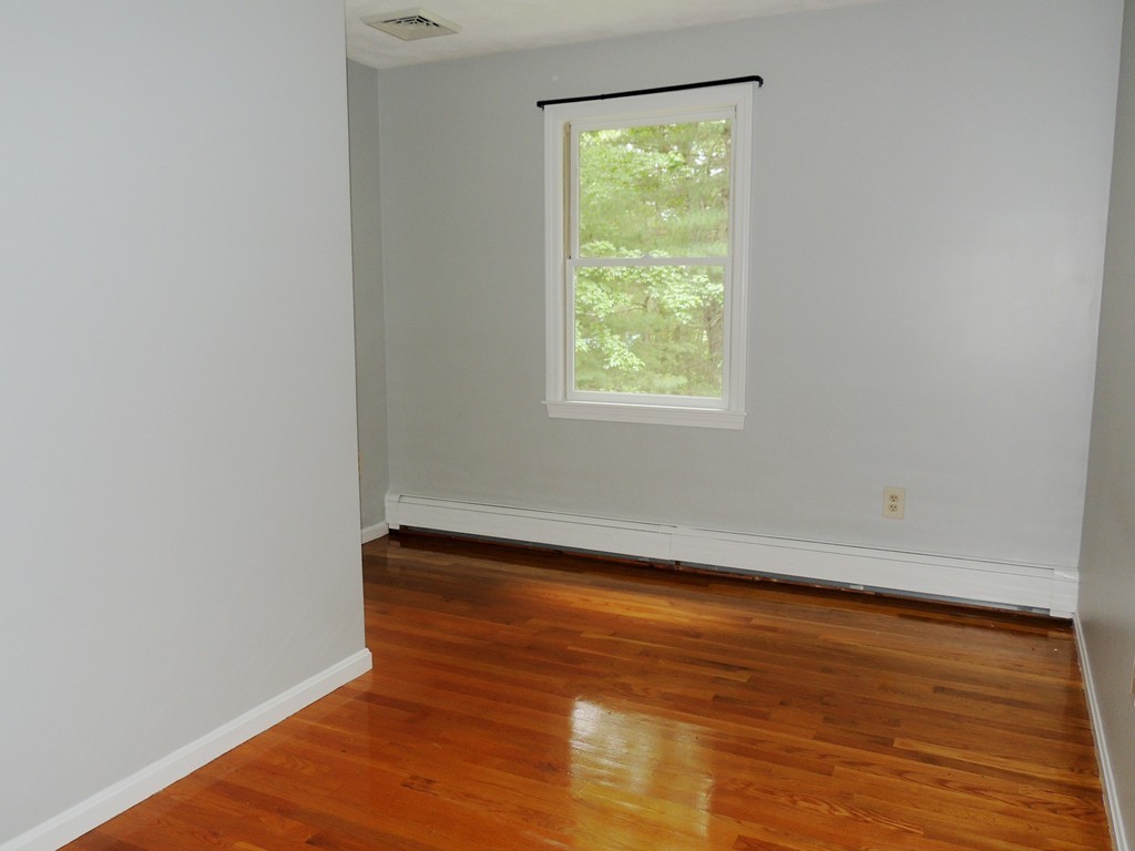 61 Judy Farm Road Carlisle, MA 01741 - Photo 16 of 24 an empty room with wooden floor and a window