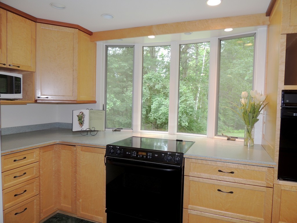 61 Judy Farm Road Carlisle, MA 01741 - Photo 7 of 24 a kitchen with a stove a sink and a microwave
