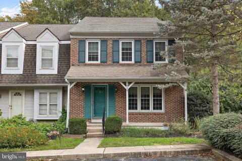 a front view of a house with garden and porch