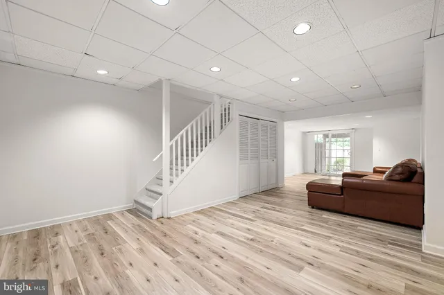 a living room with furniture and stairs
