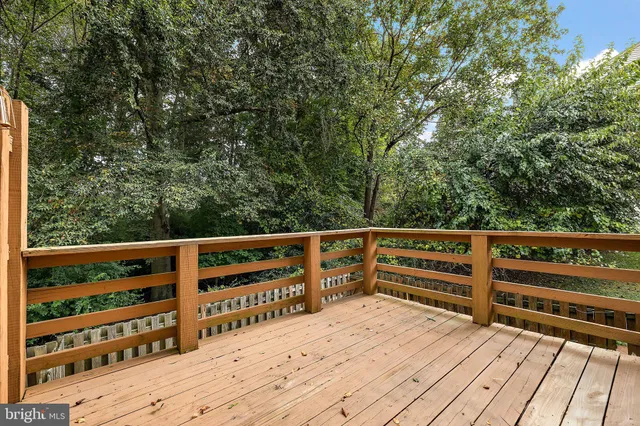 a view of balcony with wooden floor and fence