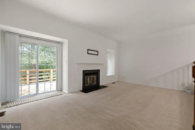 a view of empty room with a fireplace