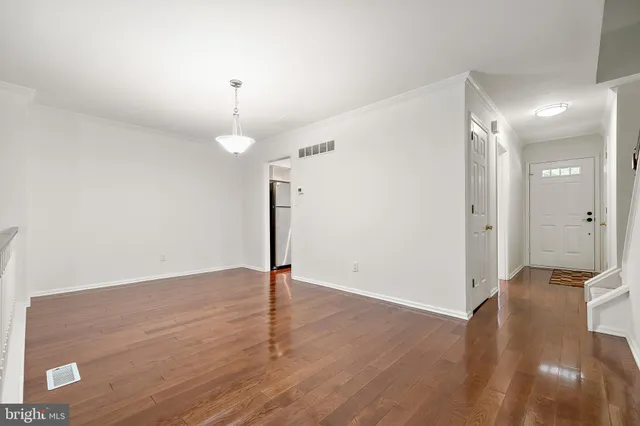 a view of a room with wooden floor