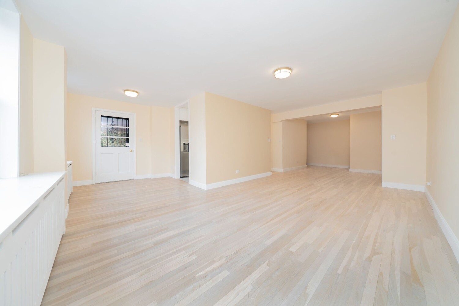 35-20 Leverich Street, Unit A403 Queens, NY 11372 - Photo 2 of 12 a view of an empty room with wooden floor
