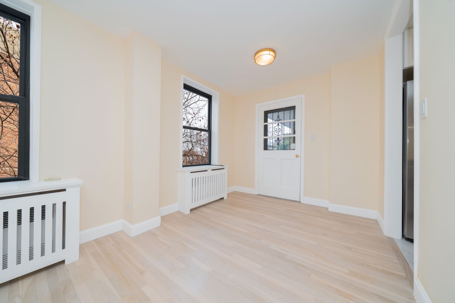 35-20 Leverich Street, Unit A403 Queens, NY 11372 - Photo 6 of 12 a view of a livingroom with wooden floor and a window
