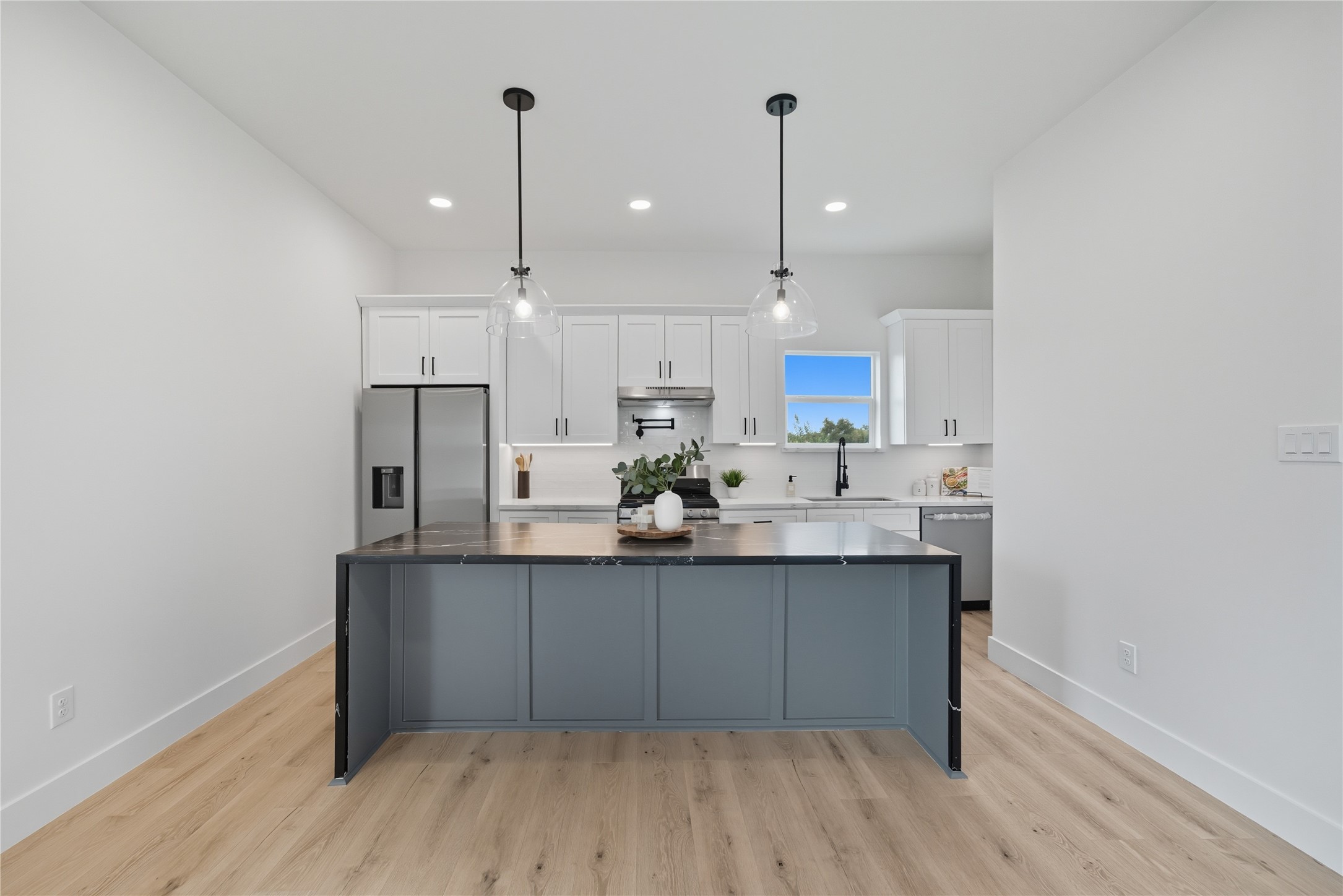 4749 Wilmington Street, Unit A Houston, TX 77033 - Photo 8 of 26 a kitchen with kitchen island a sink stainless steel appliances and cabinets