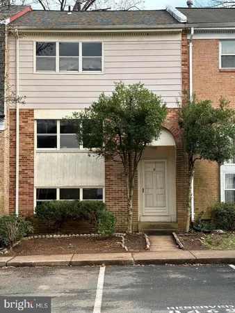 a house that has a tree in front of it