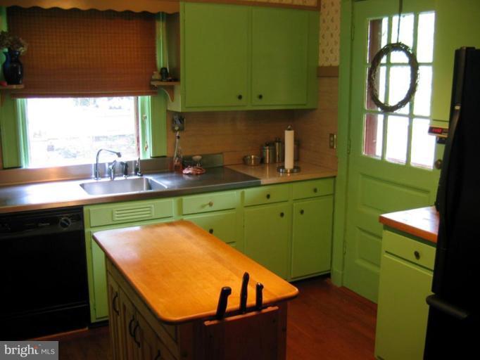 209 Hawthorn Road Baltimore, MD 21210 - Photo 21 of 28 a view of a kitchen with kitchen island a sink wooden floor and a window