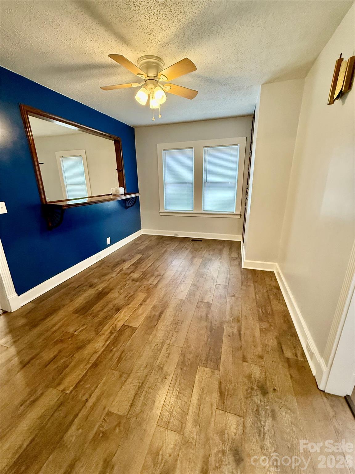 100 Perry Street Marion, NC 28752 - Photo 11 of 20 a view of an empty room with wooden floor and a window