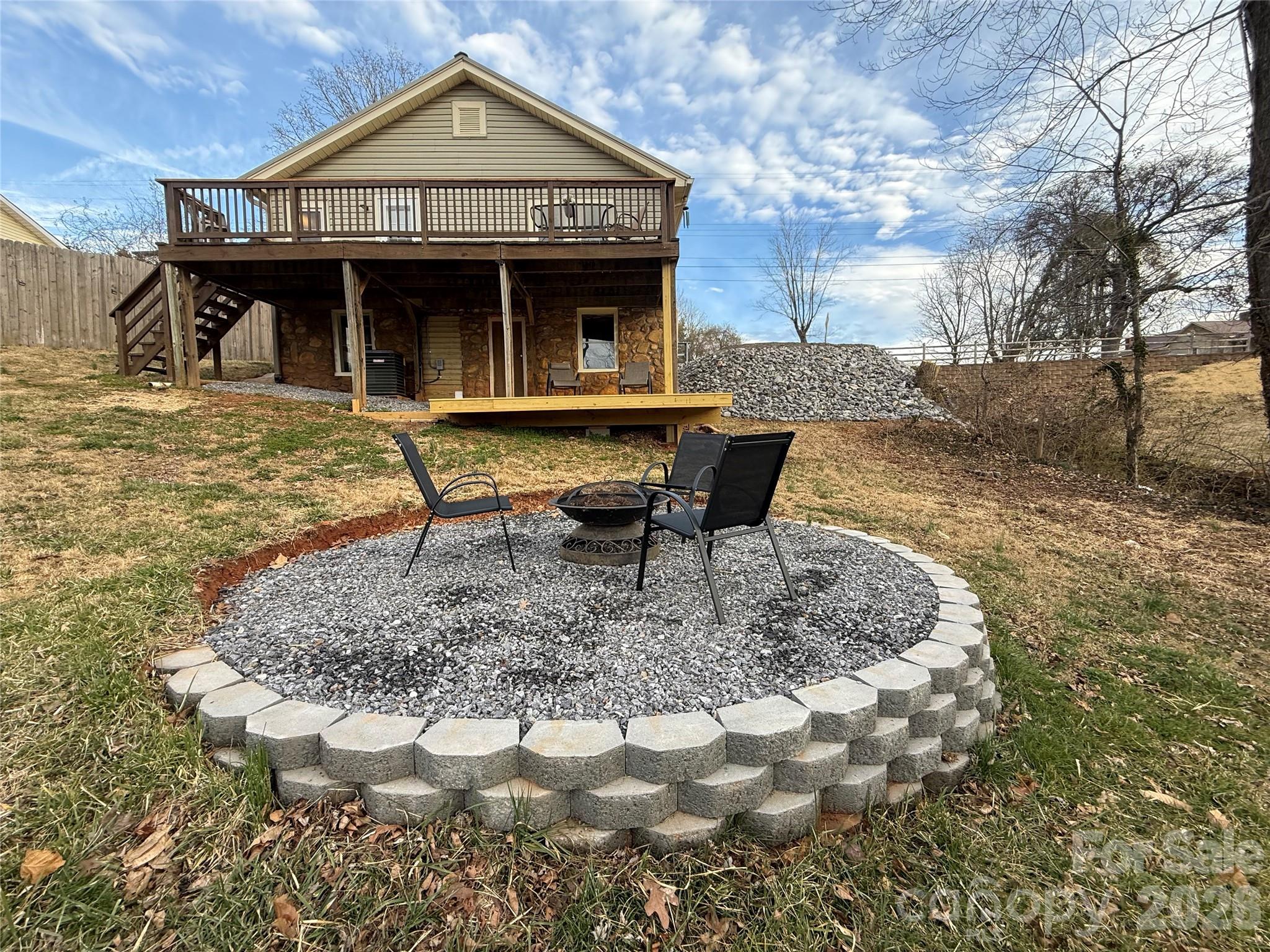 100 Perry Street Marion, NC 28752 - Photo 5 of 20 a backyard of a house with table and chairs