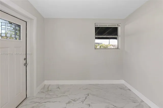 an empty room with windows and closet