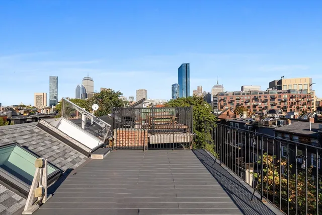 a view of a roof deck with furniture