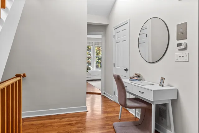 a view of a room with wooden floor potted plant and windows