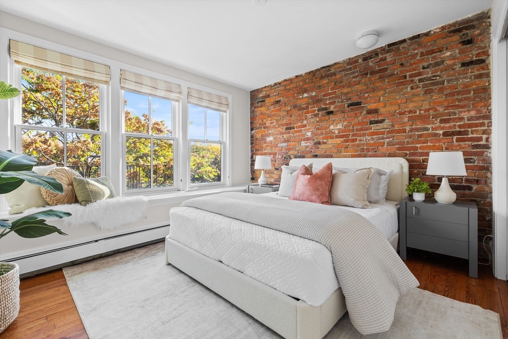 81 Waltham Street, Unit 6 Boston, MA 02118 - Photo 16 of 24 a bed room with a bed and a couch