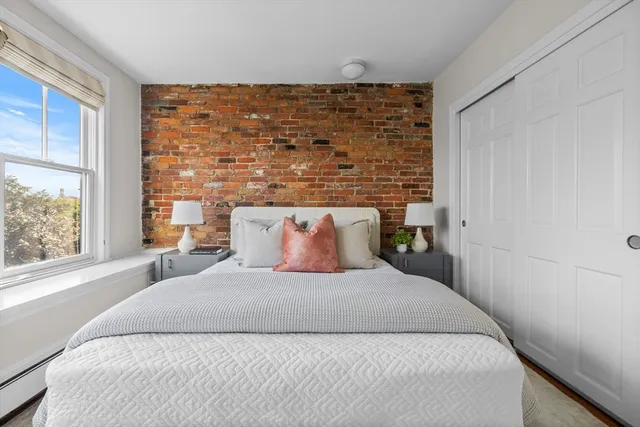 a bedroom with a large bed and a large window