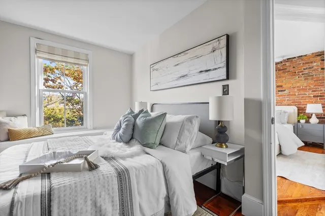 a bedroom with a bed and window