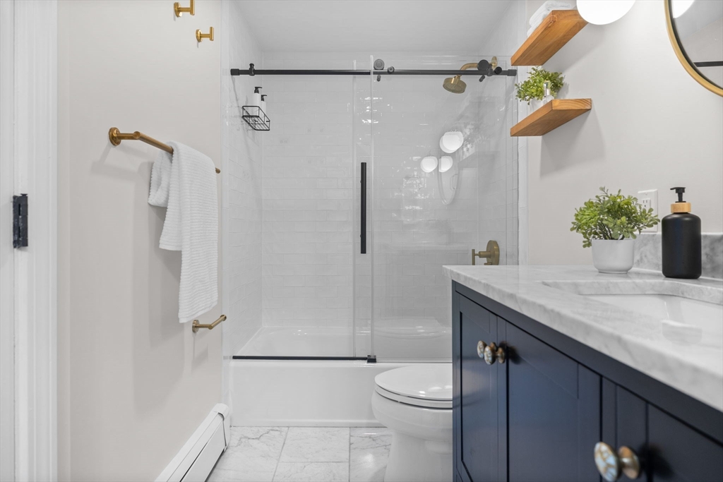 81 Waltham Street, Unit 6 Boston, MA 02118 - Photo 21 of 24 a bathroom with a granite countertop sink a toilet and shower