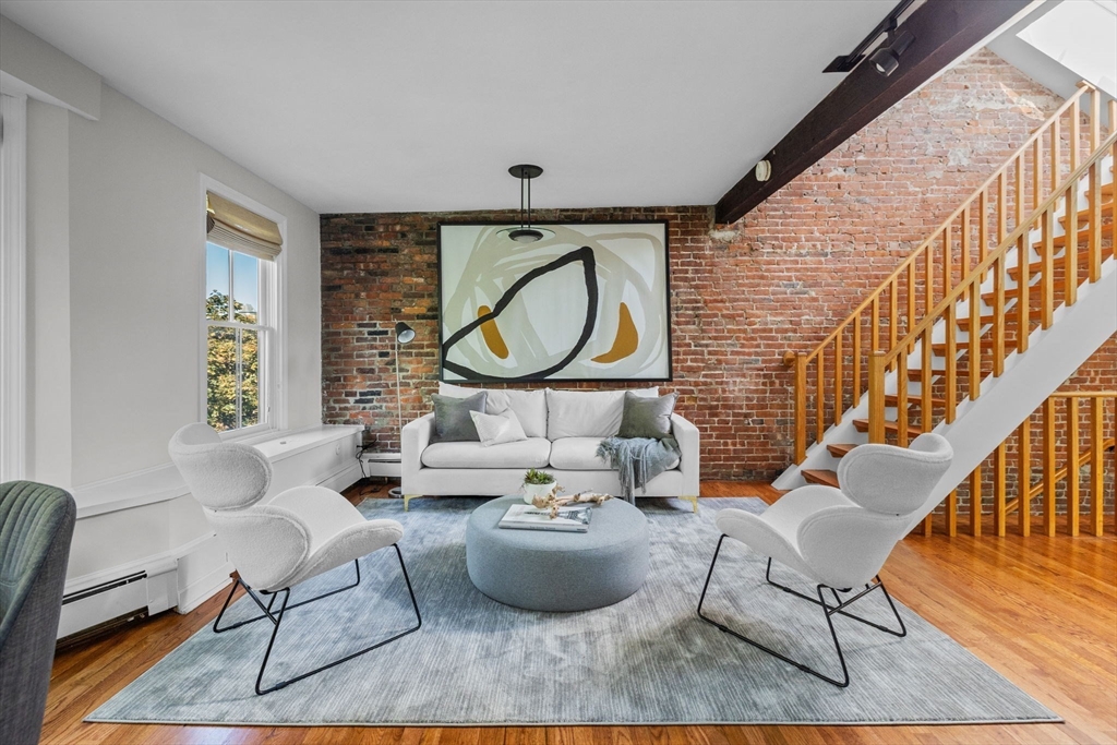 81 Waltham Street, Unit 6 Boston, MA 02118 - Photo 3 of 24 a living room with furniture and a large window