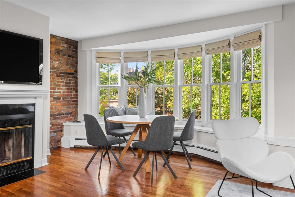 81 Waltham Street, Unit 6 Boston, MA 02118 - Photo 5 of 24 a view of a dining room with furniture window and wooden floor