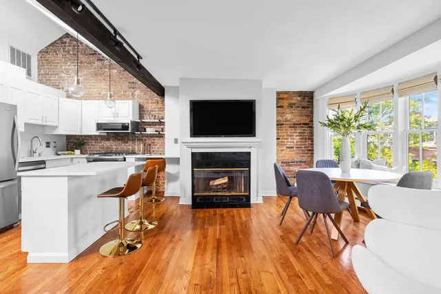 a living room with furniture a fireplace and a flat screen tv