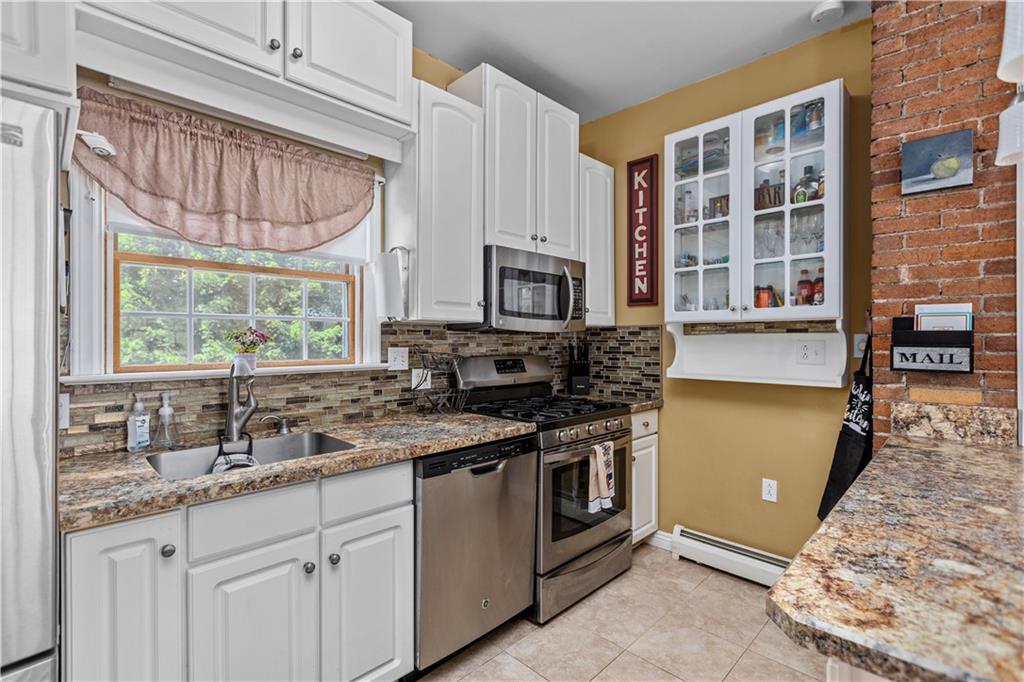 1701 Darlington Road Beaver Falls, PA 15010 - Photo 14 of 30 a kitchen with stainless steel appliances granite countertop a stove a sink and a microwave