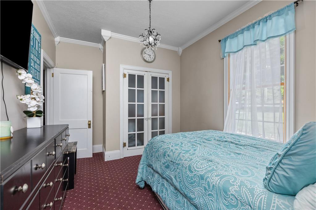 1701 Darlington Road Beaver Falls, PA 15010 - Photo 16 of 30 a bedroom with a bed dresser and a flat tv screen