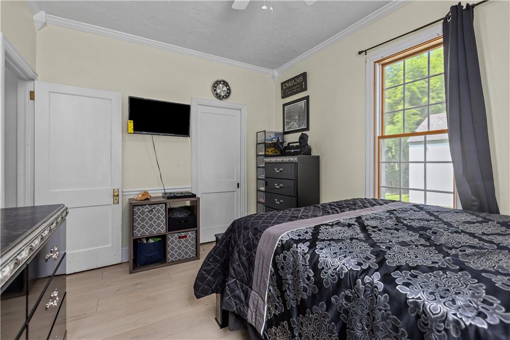 1701 Darlington Road Beaver Falls, PA 15010 - Photo 18 of 30 a bedroom with a bed and a flat tv screen on dresser