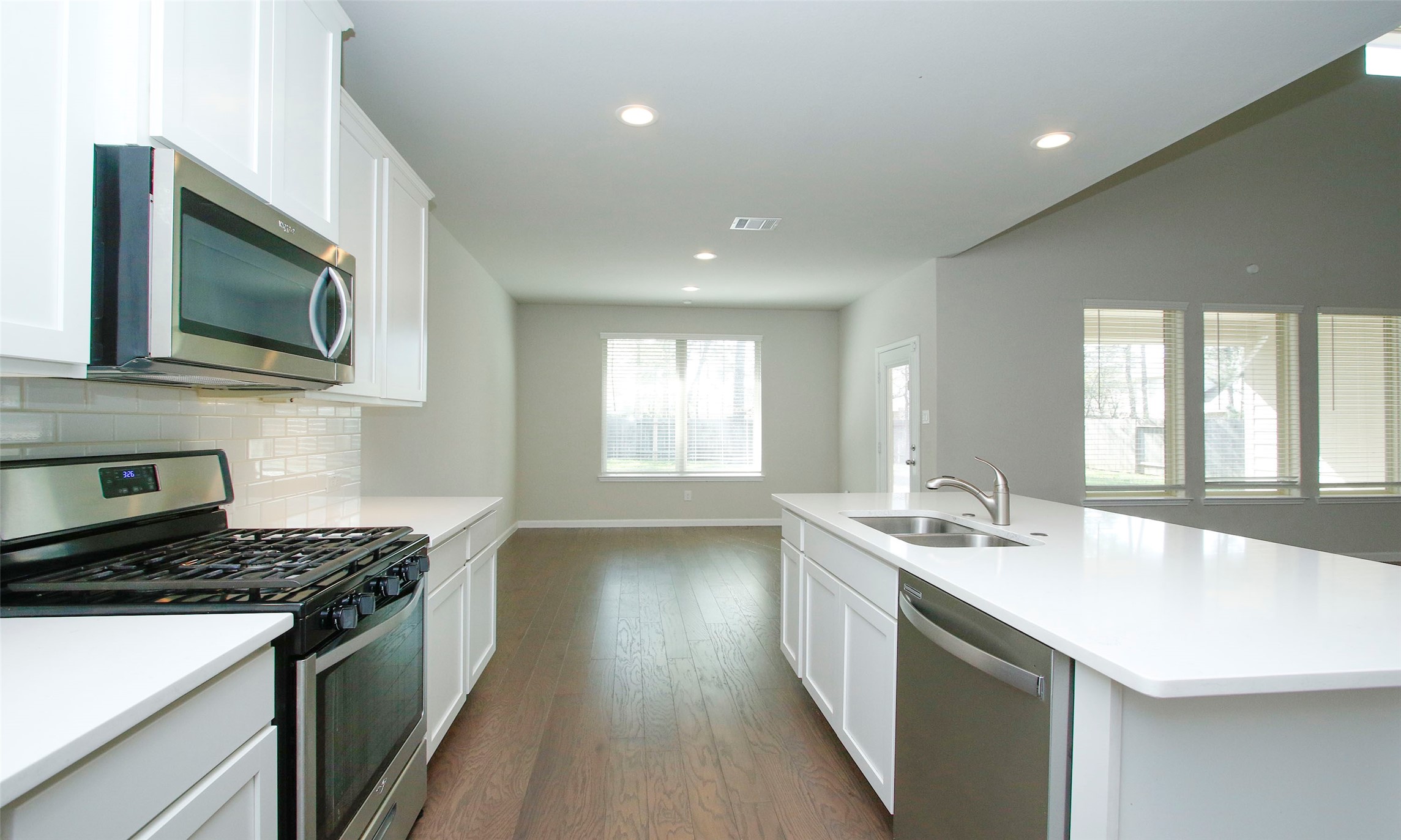 14120 Sand Ridge Court Conroe, TX 77384 - Photo 18 of 43 a kitchen with a stove and a microwave