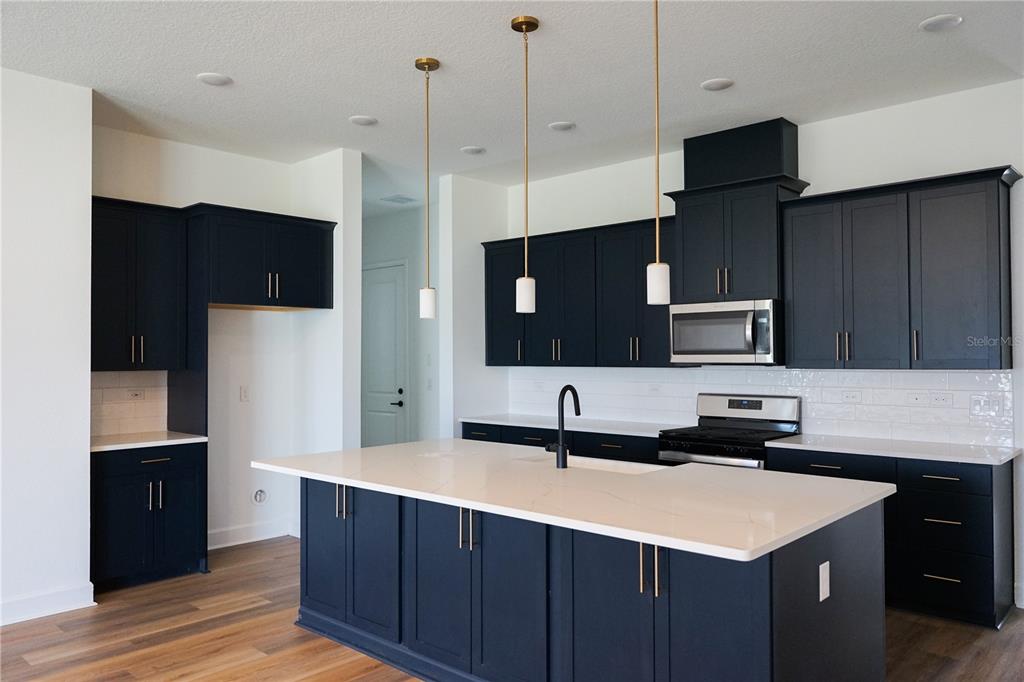 Undisclosed Address Palm Coast, FL 32137 - Photo 2 of 14 a kitchen with granite countertop a sink and a stove