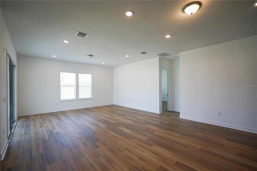 Undisclosed Address Palm Coast, FL 32137 - Photo 3 of 14 a view of an empty room with wooden floor and a window
