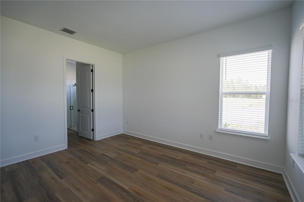 Undisclosed Address Palm Coast, FL 32137 - Photo 5 of 14 an empty room with wooden floor and windows