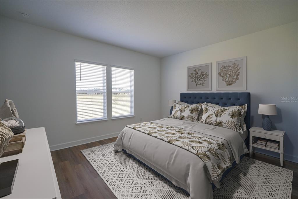 Undisclosed Address Palm Coast, FL 32137 - Photo 7 of 14 a bedroom with a large bed and wooden floor