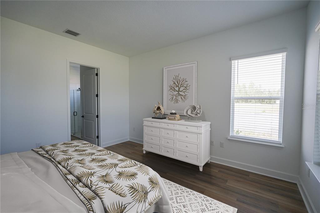 Undisclosed Address Palm Coast, FL 32137 - Photo 8 of 14 a bedroom with a bed and a window