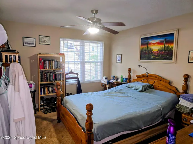 a bed room with a bed and a bookshelf