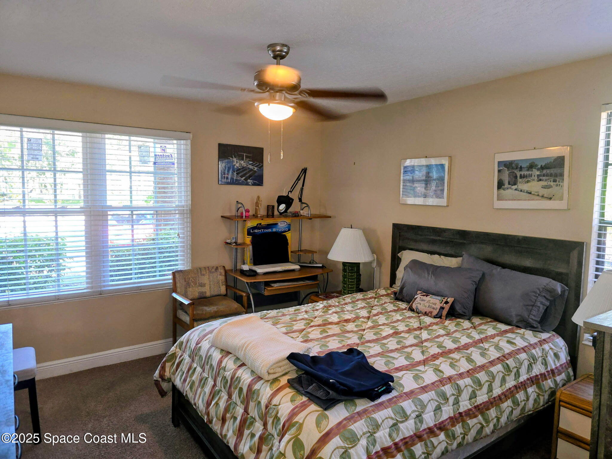 7667 North Wickham Road, Unit 501 Melbourne, FL 32940 - Photo 13 of 33 a bedroom with a bed a table and chair