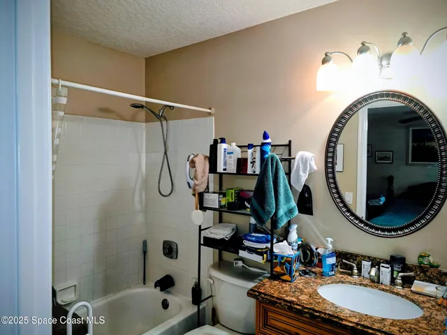 a bathroom with a sink mirror and vanity