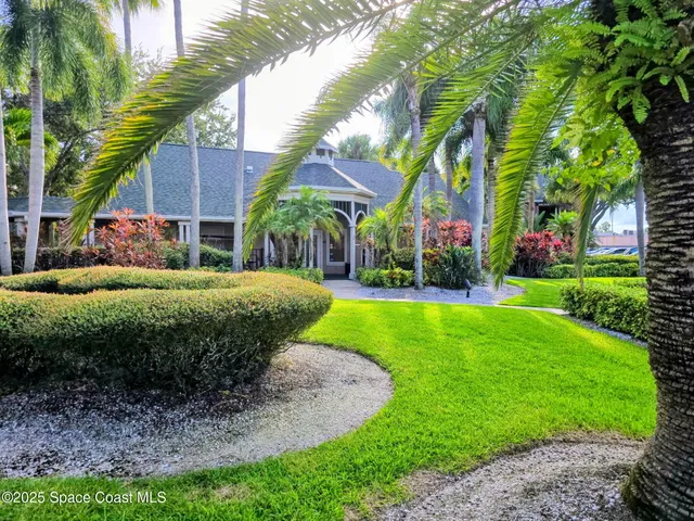 a view of a garden with a house