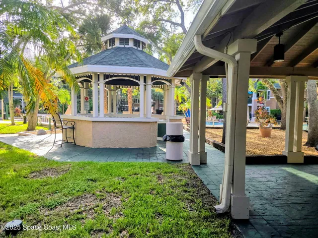a view of a house with a porch and furniture